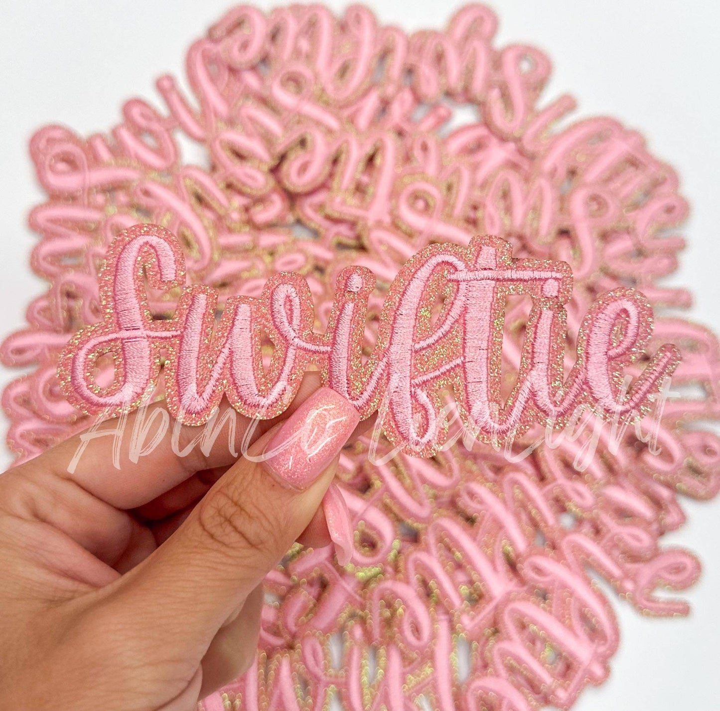 Swiftie pink cursive script letter patch iron on